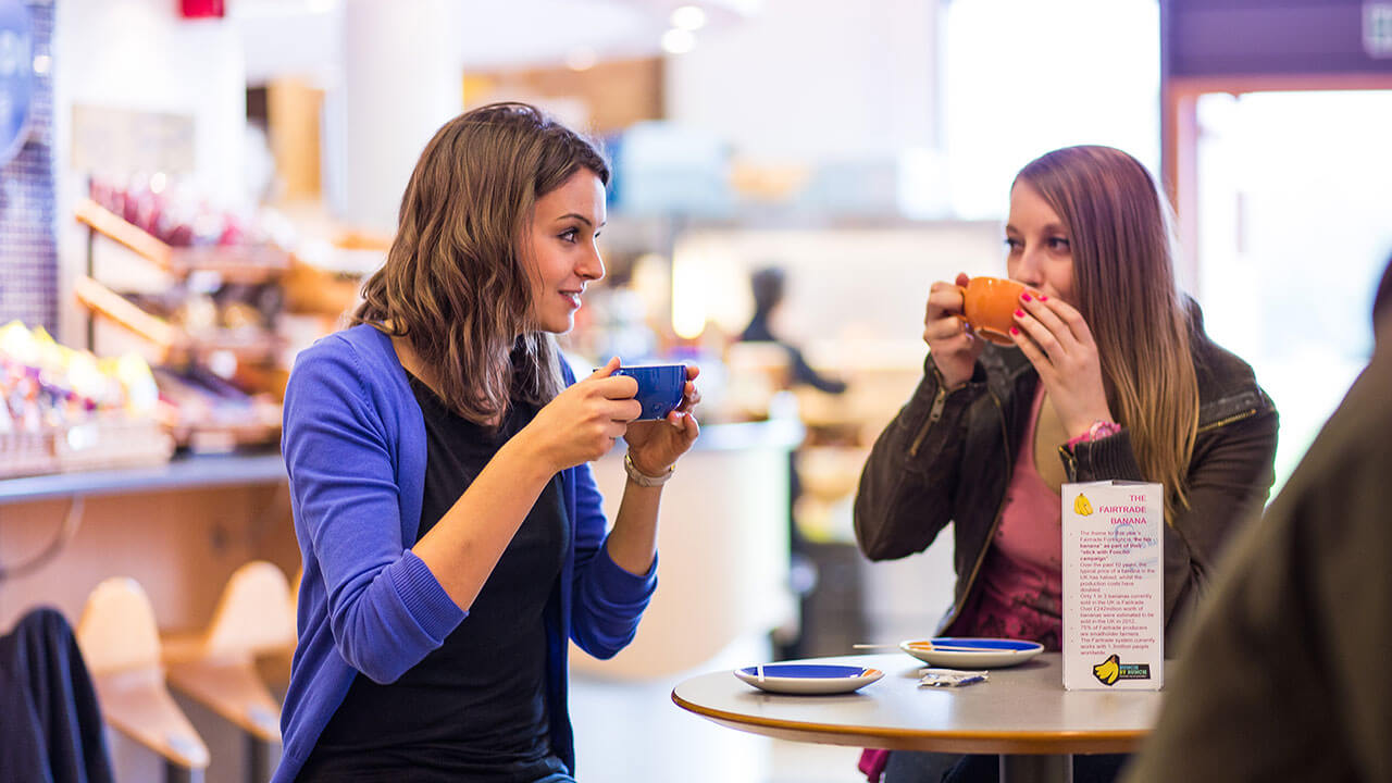 Students talking in Kaldi Cafe whilst having a coffee