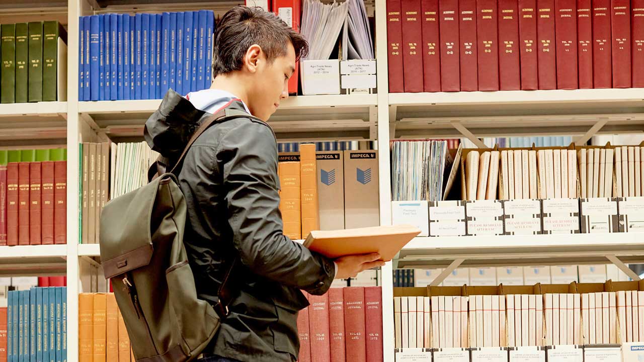 Student browsing books in the library