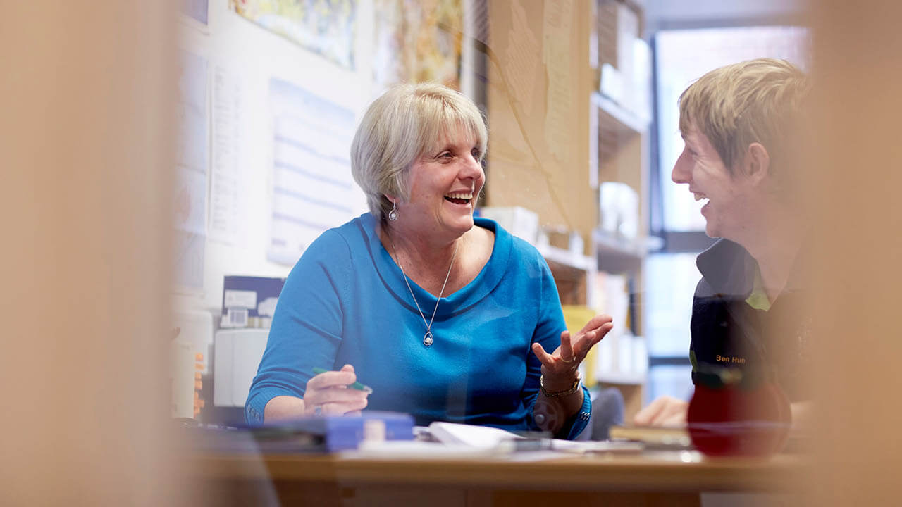 A member of staff and a student discussing available support
